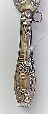 Antique silver rattle with pink decoration from the late 19th century