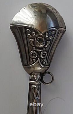 Antique silver rattle with rose decoration, late 19th century