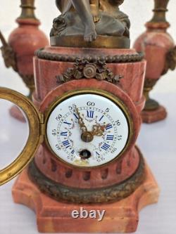 Bronze mantel clock with cherub, cassolette candleholders, Louis XVI style, 19th century period