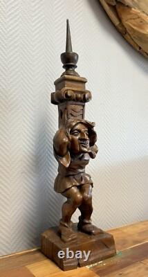 Carved wooden candle holder depicting a grotesque character, 19th century