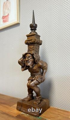 Carved wooden candle holder depicting a grotesque character, 19th century