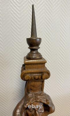 Carved wooden candle holder depicting a grotesque character, 19th century