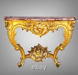 Nineteenth-century gilded and carved wooden console table with a veined red marble top