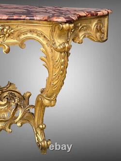 Nineteenth-century gilded and carved wooden console table with a veined red marble top