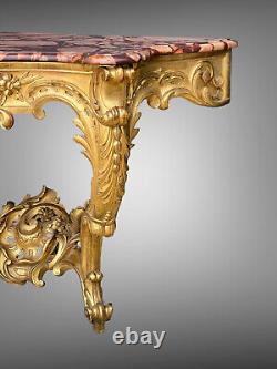 Nineteenth-century gilded and carved wooden console table with a veined red marble top