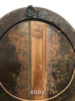 Oil painting on panel of a young woman with flowers, 19th century.