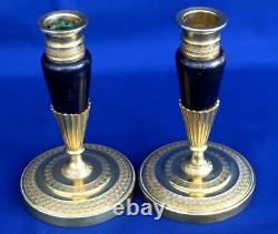 Pair of Empire-era candlesticks for the toilet table, gilt and patinated bronze, 19th century