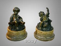 Pair of bronze patinated putti resting on marble bases from the 18th/19th century