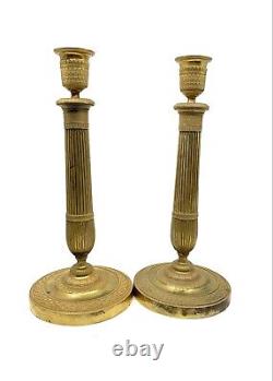 Pair of gilded bronze candlesticks from the early 19th century Empire period.