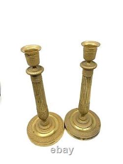 Pair of gilded bronze candlesticks from the early 19th century Empire period.