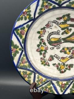 Persian faience dish with polychrome bird and flower decoration, Qajar period, 19th century