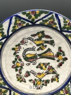 Persian faience dish with polychrome bird and flower decoration, Qajar period, 19th century