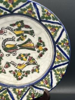 Persian faience dish with polychrome bird and flower decoration, Qajar period, 19th century
