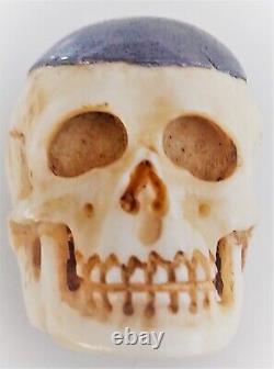 Translation: 'Ancient Memento-Mori Vanity: Lead-covered Skull in Bone, Late 19th Century'