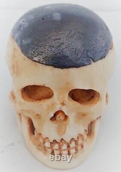 Translation: 'Ancient Memento-Mori Vanity: Lead-covered Skull in Bone, Late 19th Century'