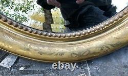 Grand miroir ovale en bois et stuck doré époque XIX ème siècle