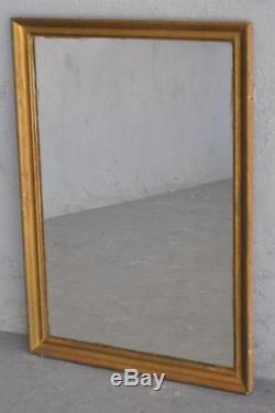 Miroir ancien en bois et stuc bronziné d'époque fin XIXème