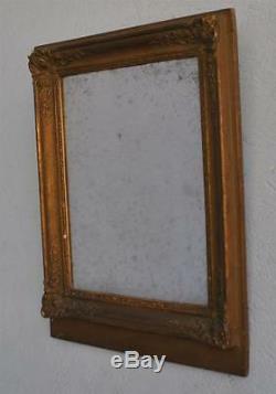 Miroir ancien en bois et stuc bronziné d'époque fin XIXème