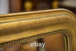 Miroir au mercure époque Louis Philippe doré à la feuille XIXème